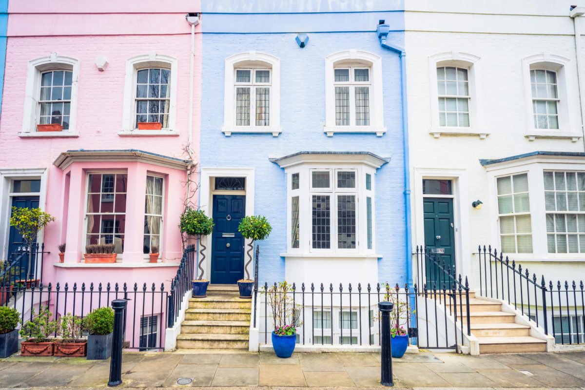 Vibrant row of pink, blue, white houses